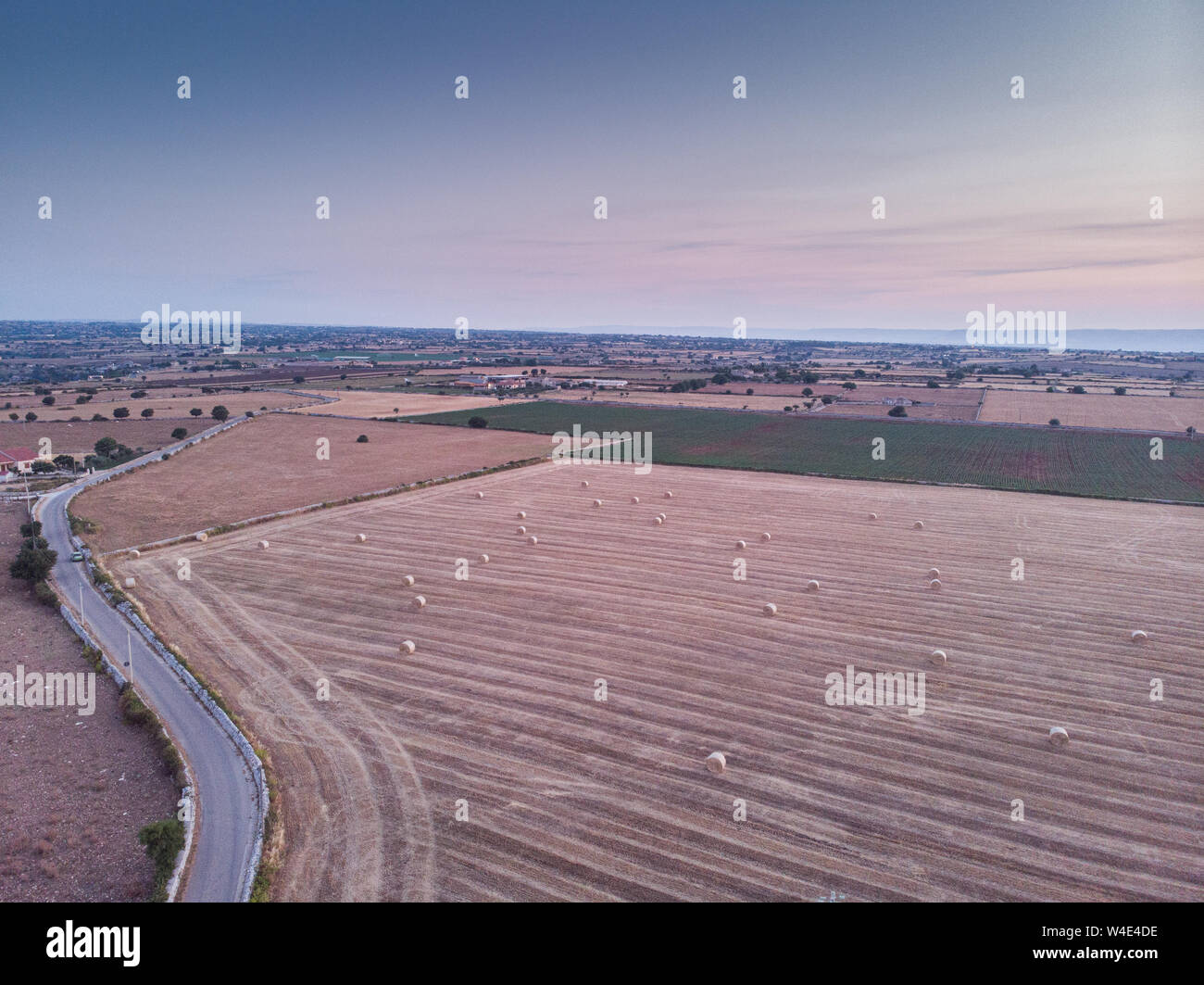 Aerial view of a field full of wheat bales. The shot is taken in a ...