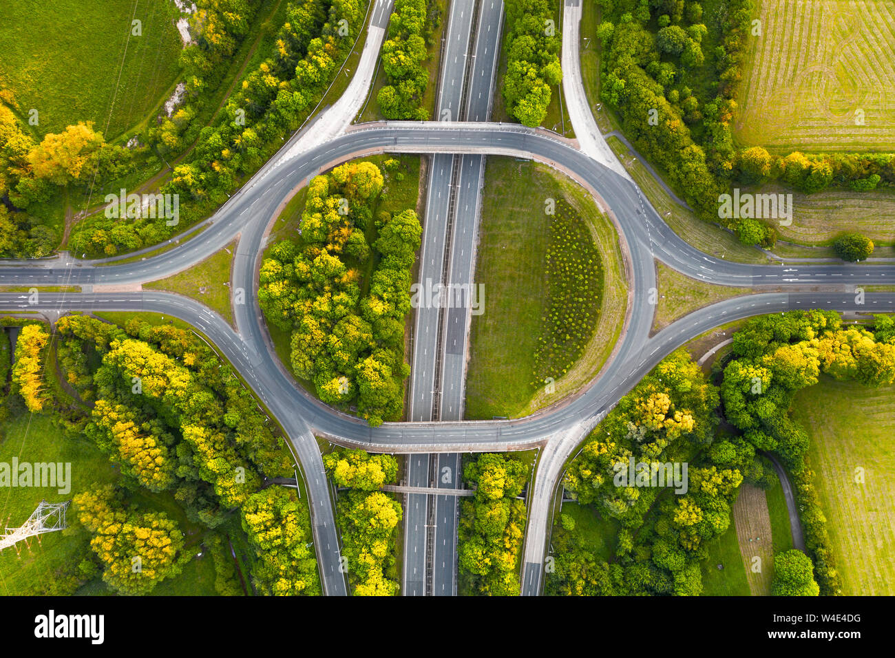 Birds eye view of a typical British highway intersection, shot on a very quiet evening during sunset with no traffic. Stock Photo