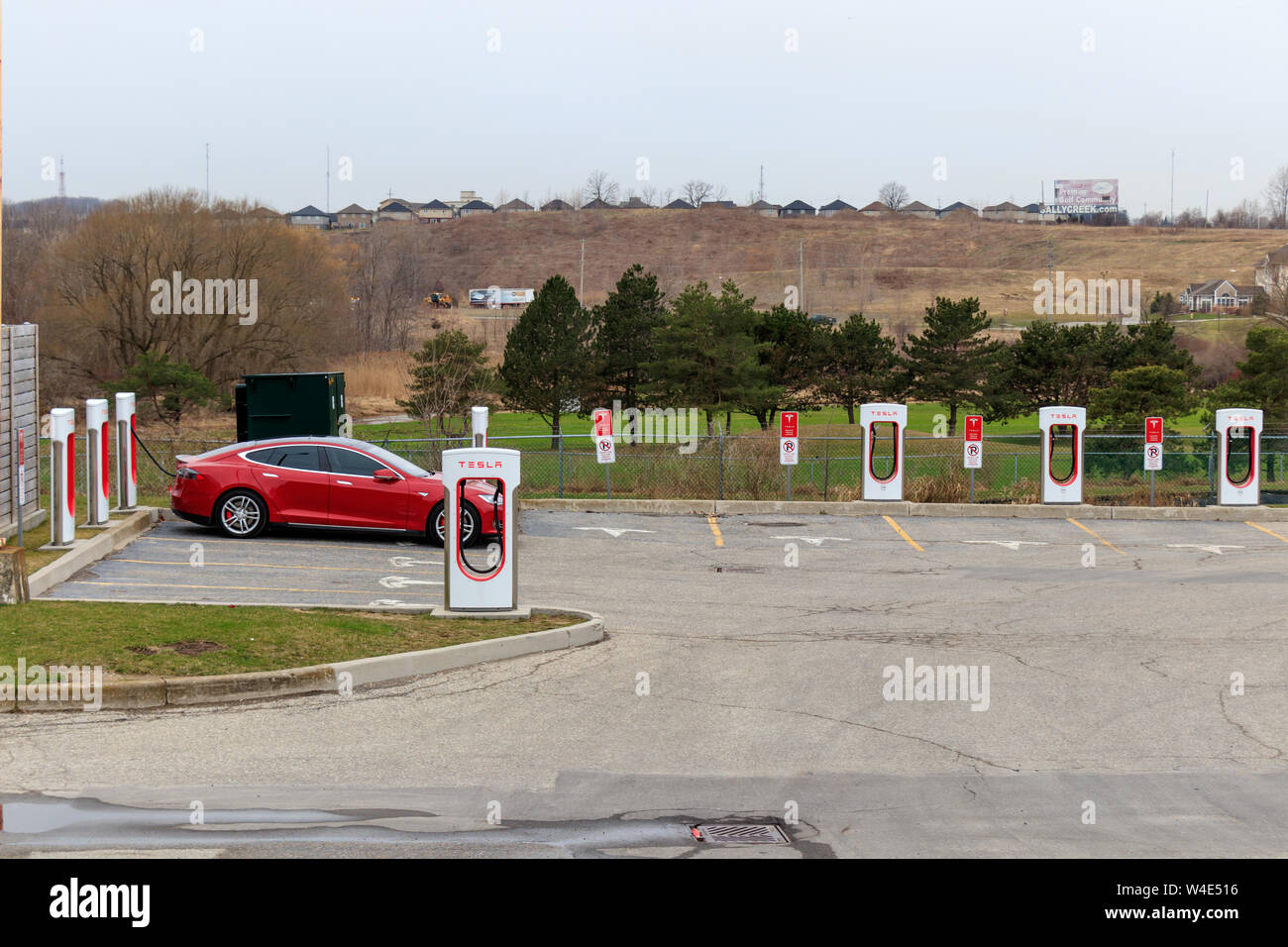 Tesla Supercharger Station with Model S plugged-in, charging. Stock Photo