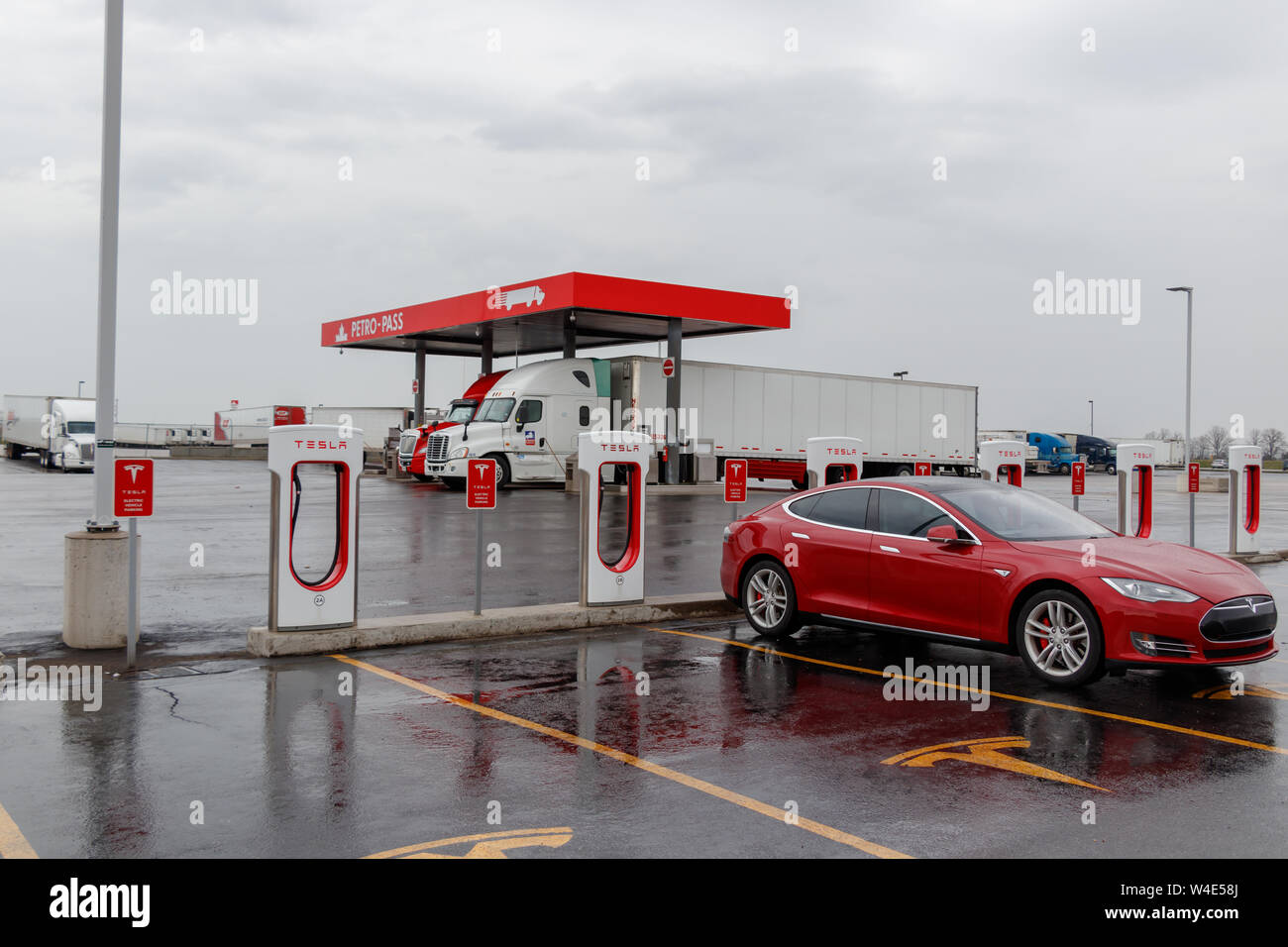 Tesla Supercharger Station with red Model S charging truck stop