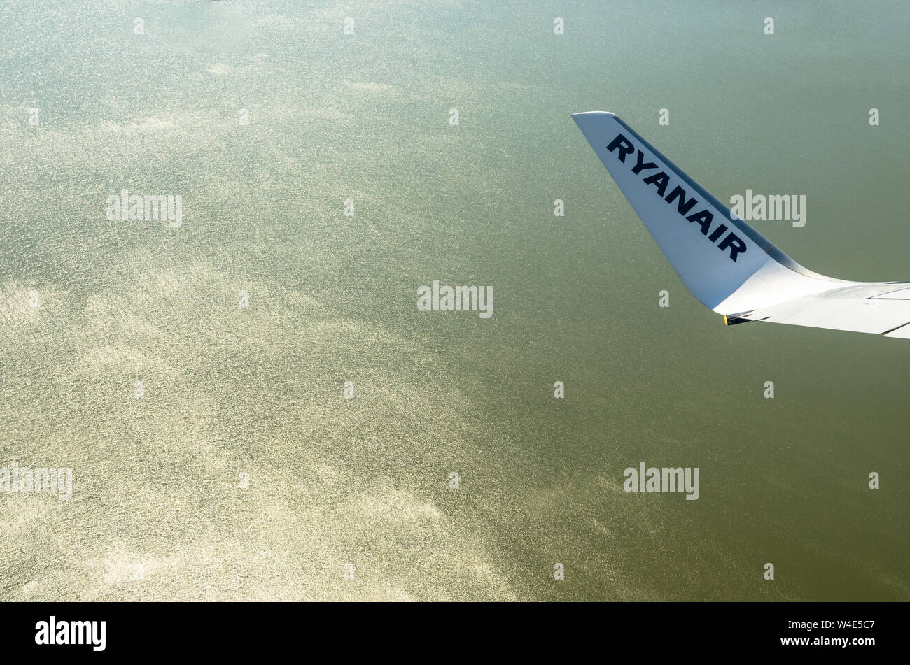 Ryainair Aircraft wingtip against the sea Stock Photo