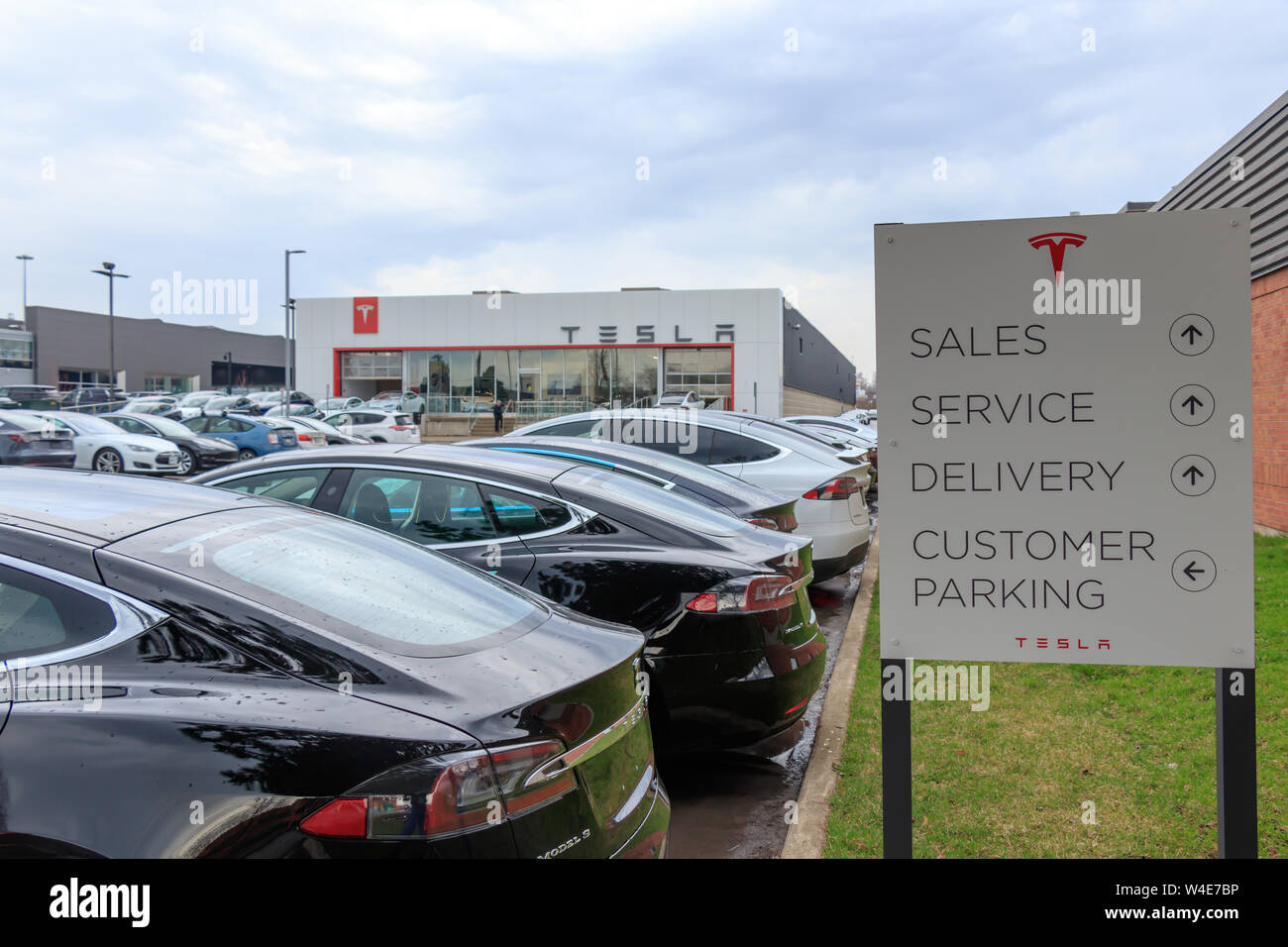 Tesla Oakville Dealership / Service Center and directory sign, seen with Tesla vehicles in the
