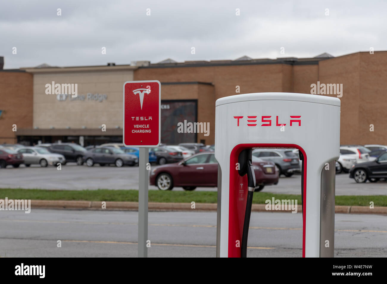 Tesla Supercharger Stall and Tesla Vehicle Charging sign in-front of CF Limeridge Mall in Hamilton, Ontario. Stock Photo