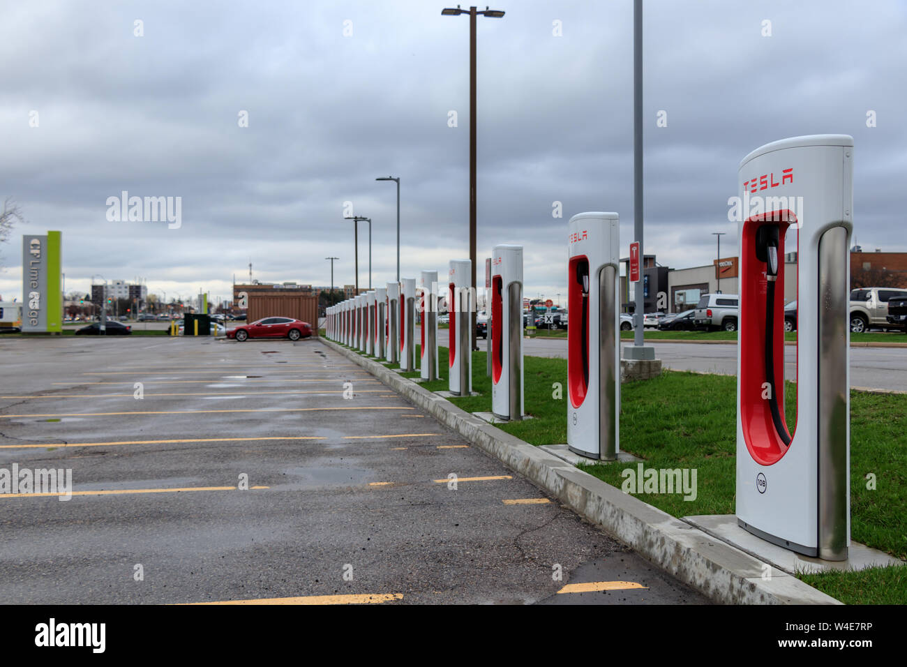 Tesla Supercharger Station with 20 Stalls and Tesla Model S charging in the background at CF