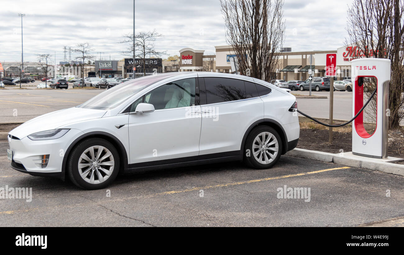 White Tesla Model X parked charging at SmartCentres Markham