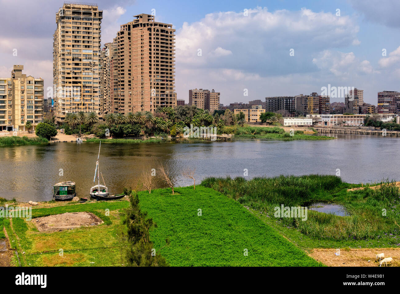 View of the rural island of Geziret El-Dahab in the Nile river from El-Monieb Bridge in Cairo Stock Photo