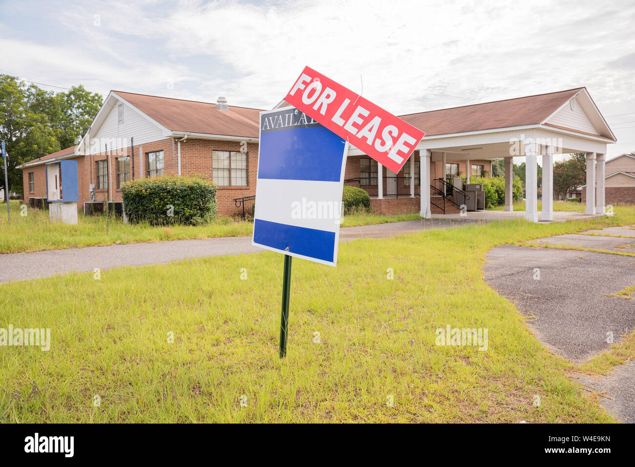 A rundown residential and commercial property in a suburban area with a