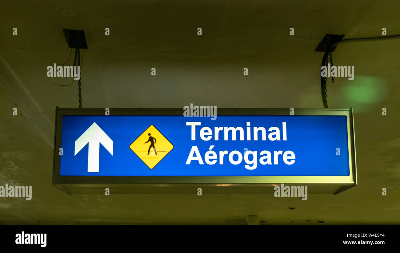 Terminal ahead, walking path sign in the parking garage of Terminal 3 at Toronto Pearson International Airport. Stock Photo