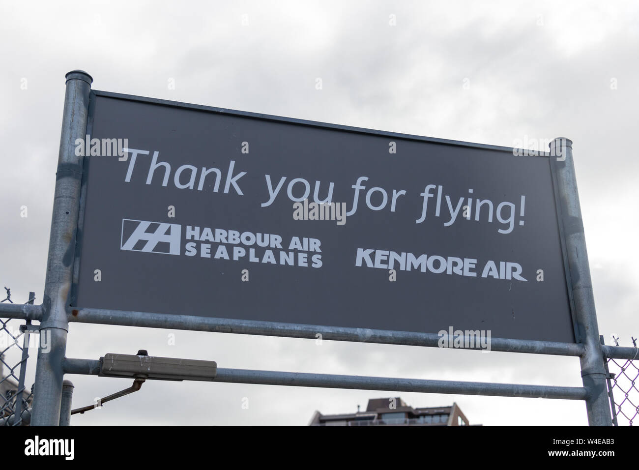 'Thank you for flying!' sign with the Harbour Air Seaplanes and Kenmore Air logos at the exit to the harbour airport in downtown Victoria, BC Stock Photo