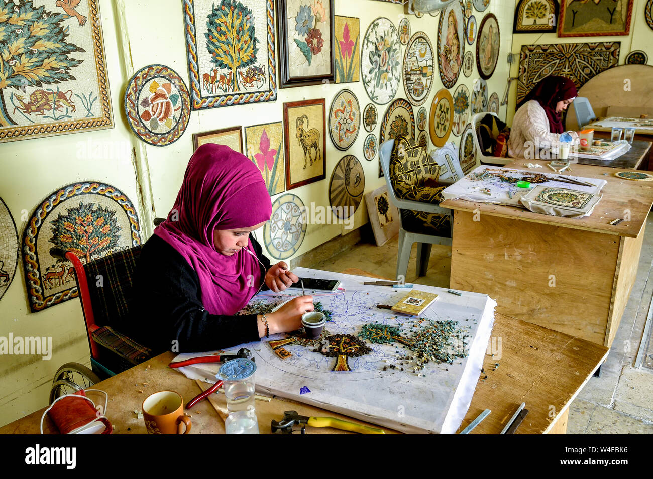 Handicapped craftspersons working on Mosaics as part of the Noor Al Hussein Foundation Community Development Program under the auspices of Queen Rania Stock Photo
