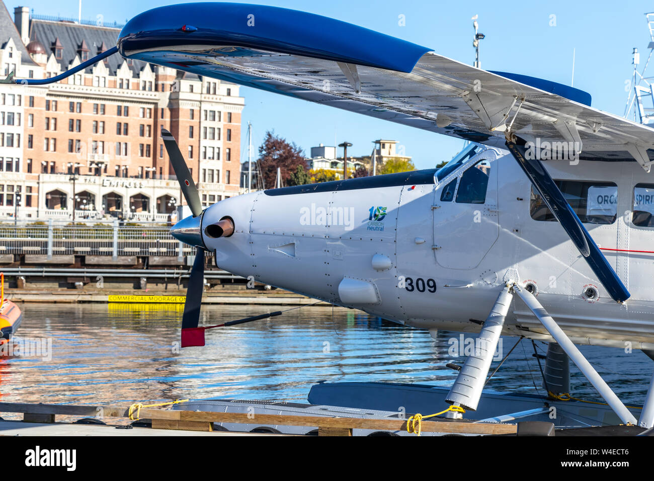 Harbour Air DHC-3 De Havilland Otter seen while docked in downtown Victoria, BC with The Empress hotel in the foreground. Stock Photo