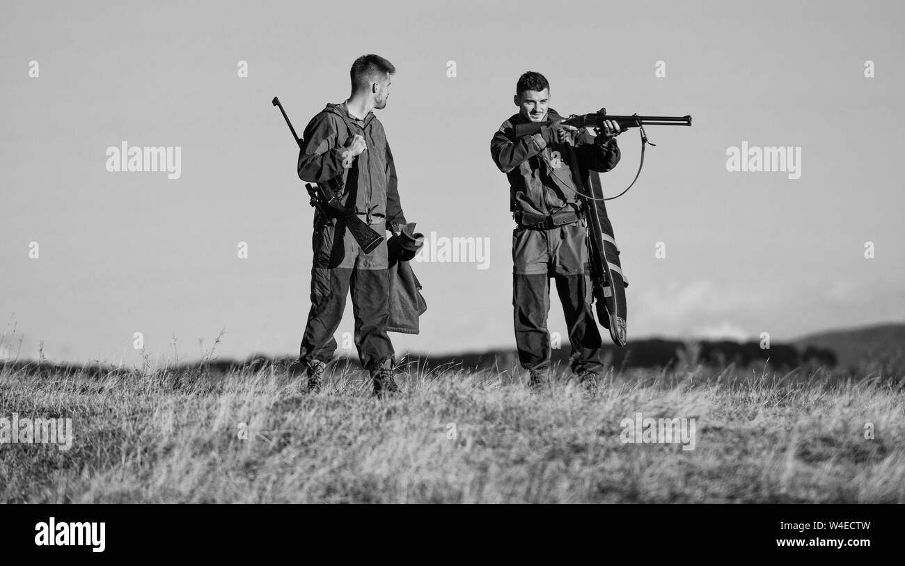 Army forces. Camouflage. Friendship of men hunters. Hunting skills and weapon equipment. How turn hunting into hobby. Military uniform fashion. Looking at target through sniper scope. Boot camp. Stock Photo