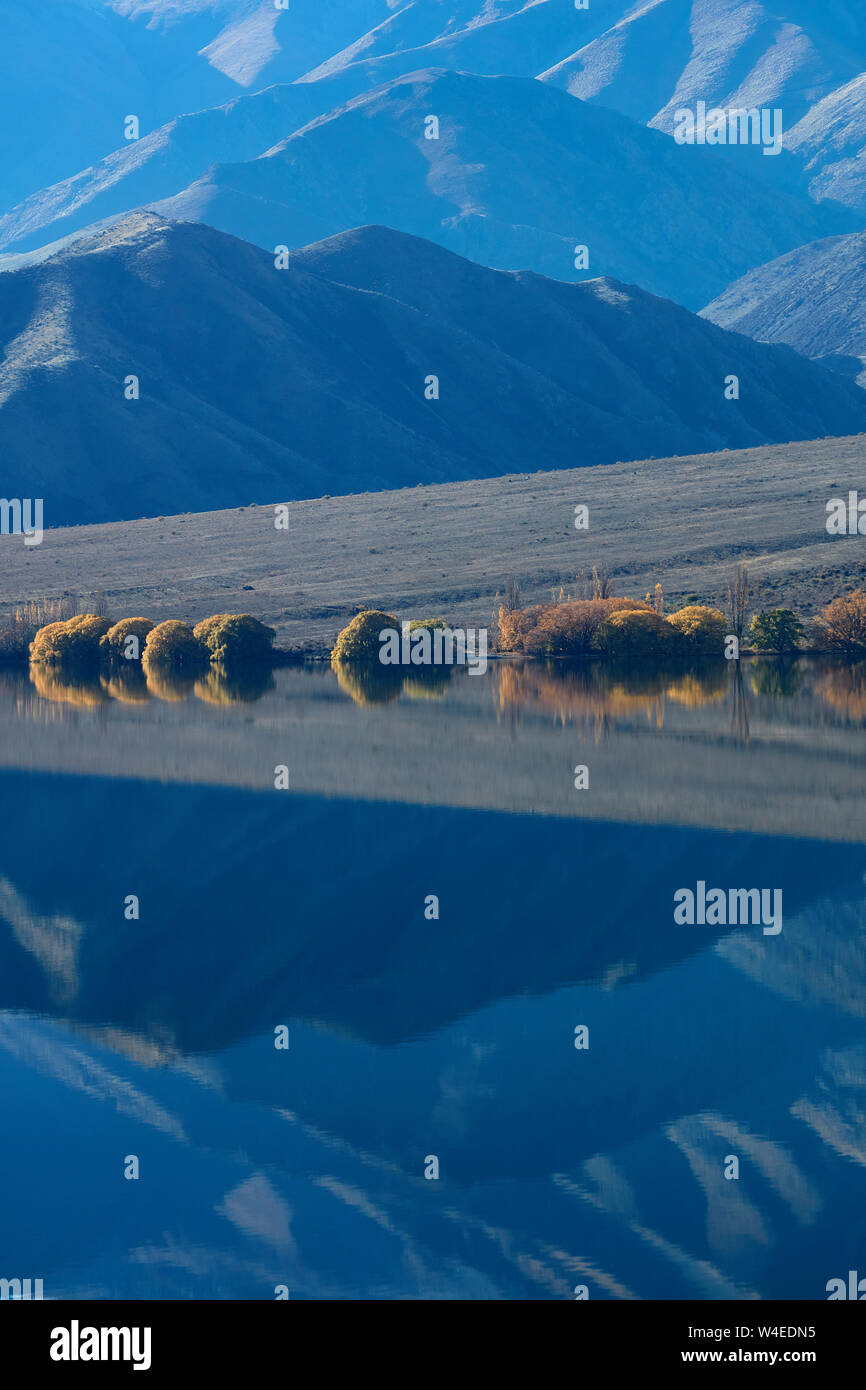 Benmore Range reflected in Lake Benmore, Waitaki Valley, North Otago, South Island, New Zealand Stock Photo
