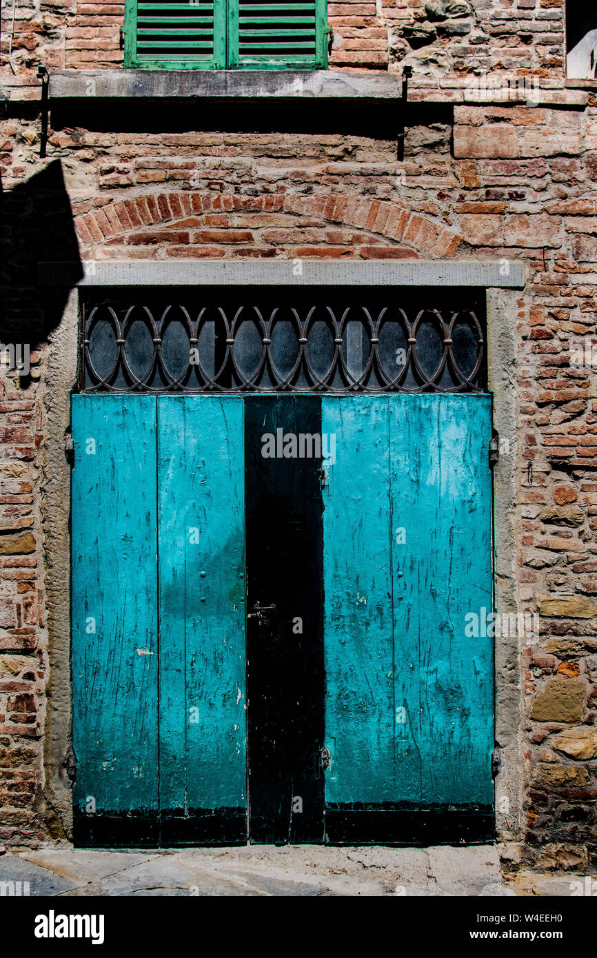 Hand-carved, antique, ornate blue door in Tuscany, Italy Stock Photo