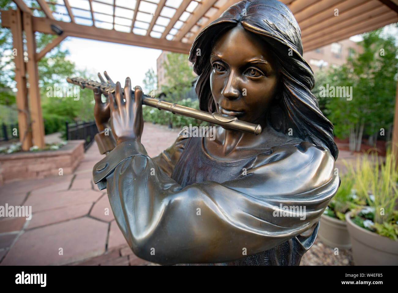 Bronze Flutist Statue in public art piece entitled 'Joy of Music' by artist George Lundeen - Golden, Colorado, USA Stock Photo