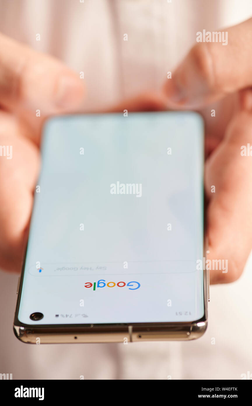 New york, USA - july 22, 2019: Using  google search mobile app close up view, smartphone in hands Stock Photo