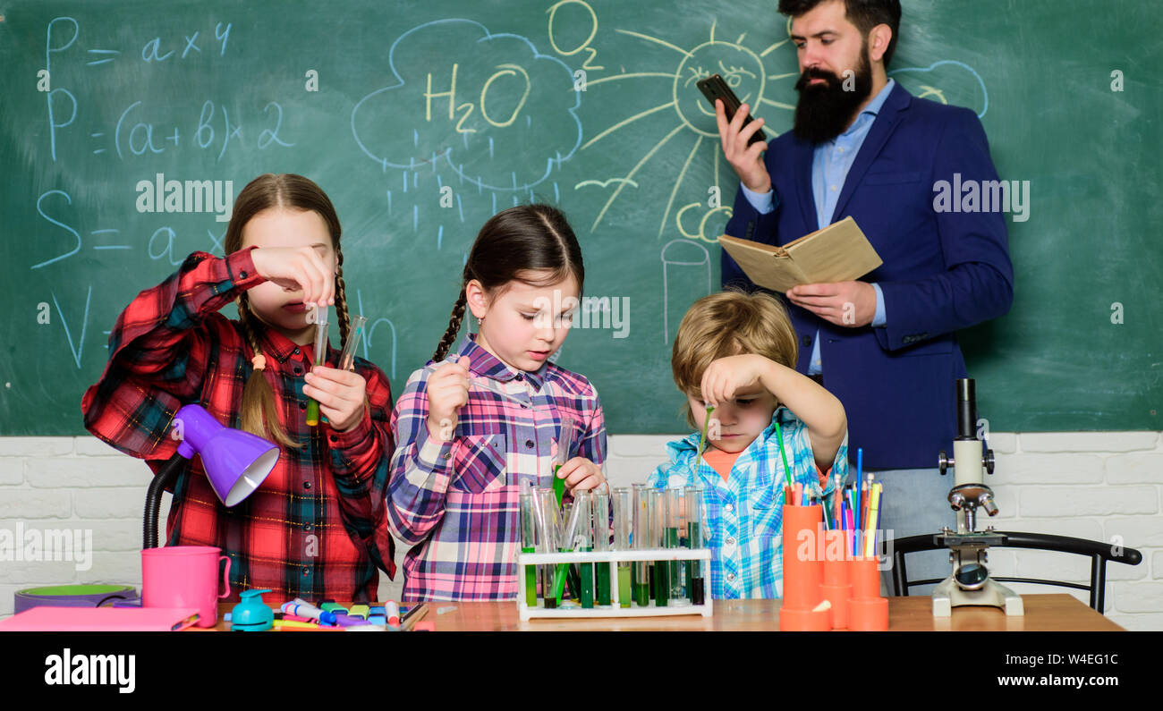 kids in lab coat learning chemistry in school laboratory. chemistry lab