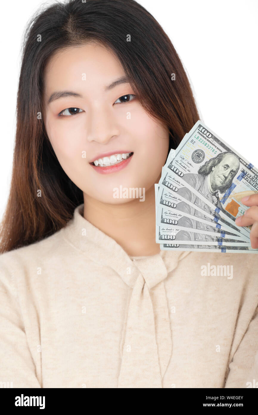 Beautiful Chinese American woman posing with American Money isolated on a white background Stock Photo