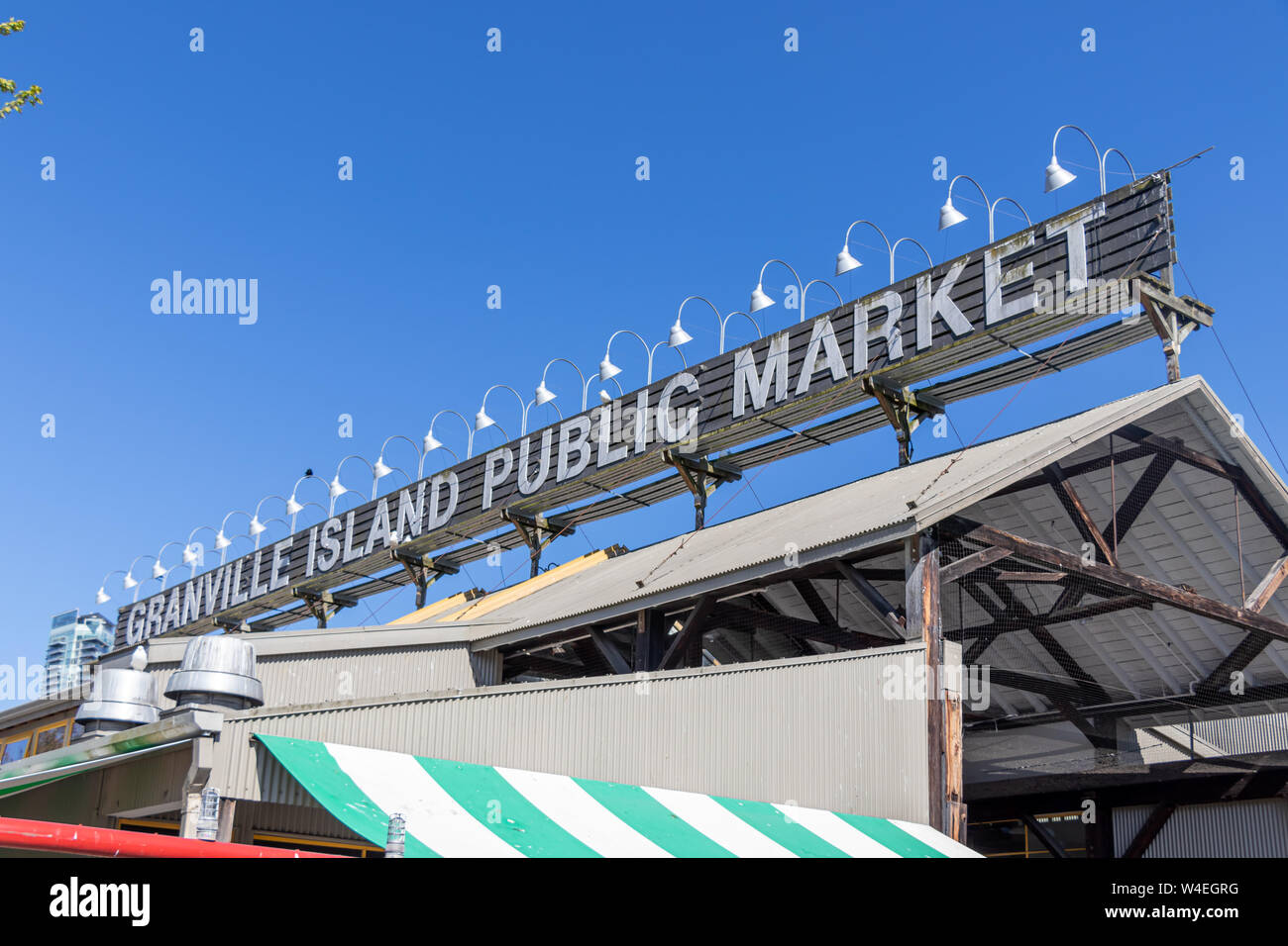Granville Island Public Market sign across the top of the main market building on clear day. Stock Photo