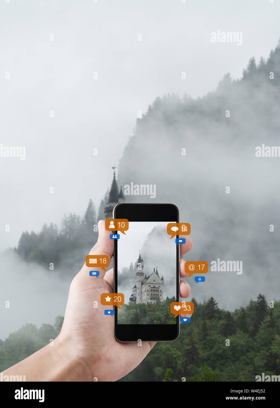 Hand using mobile smart phone taking photo of Neuschwanstein Castle in Germany, with social media and social network notification icons Stock Photo
