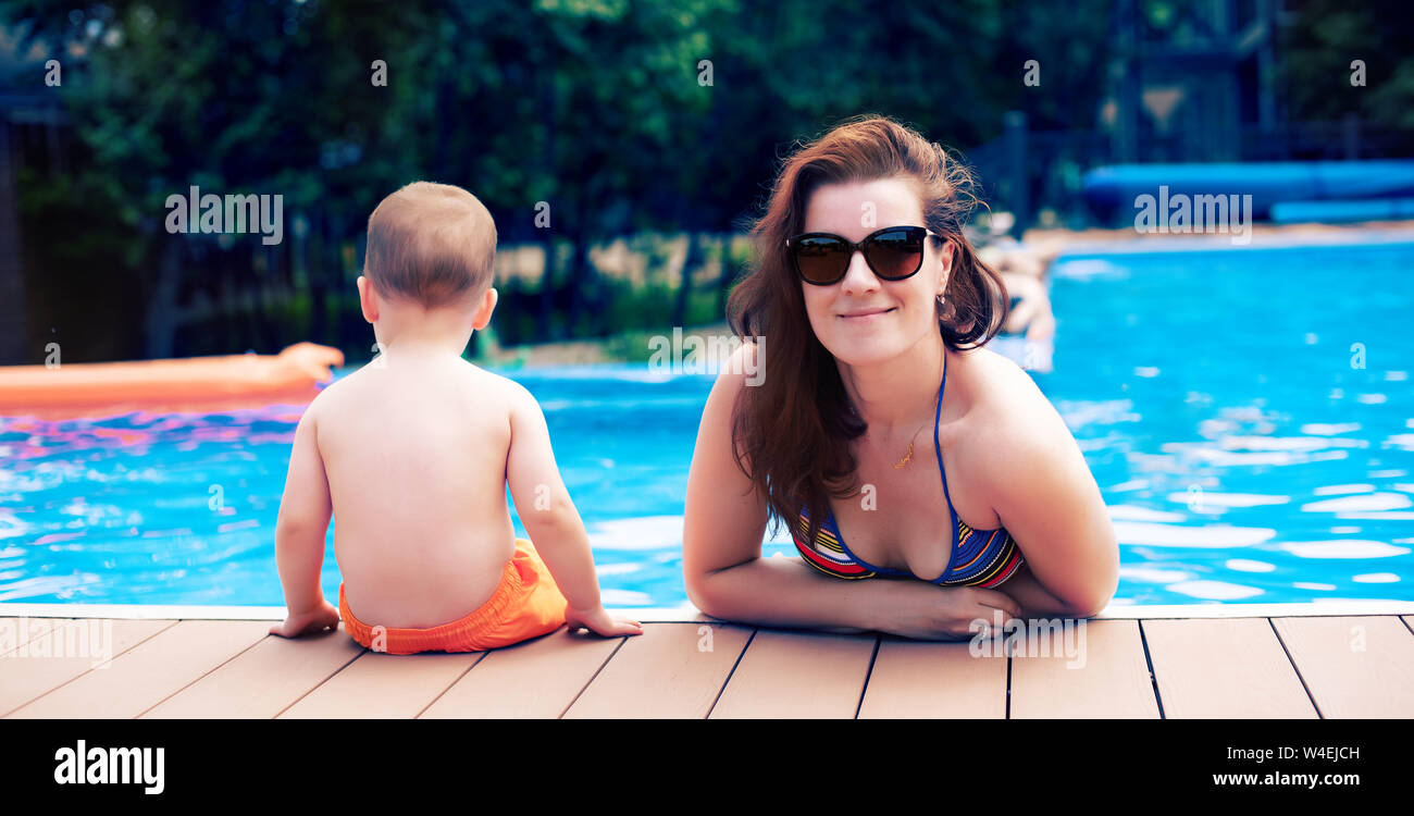 Banner Close Up Of Mother And Son By The Pool During Summer