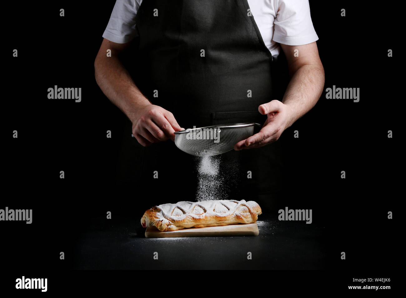 baker decorating on dark background. recipe concept. Stock Photo