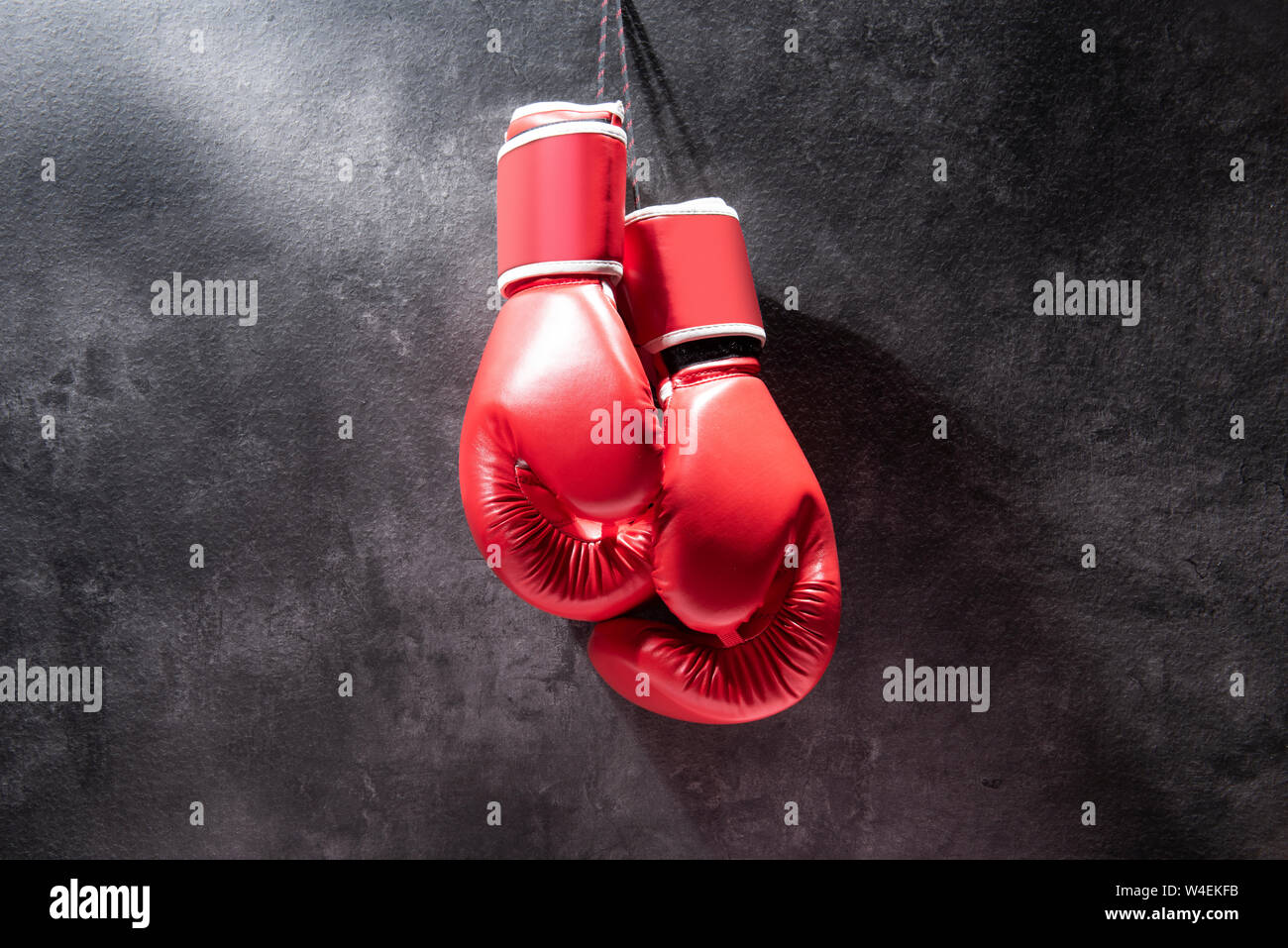 Pair of red boxing gloves hanging on the wall Stock Photo Alamy