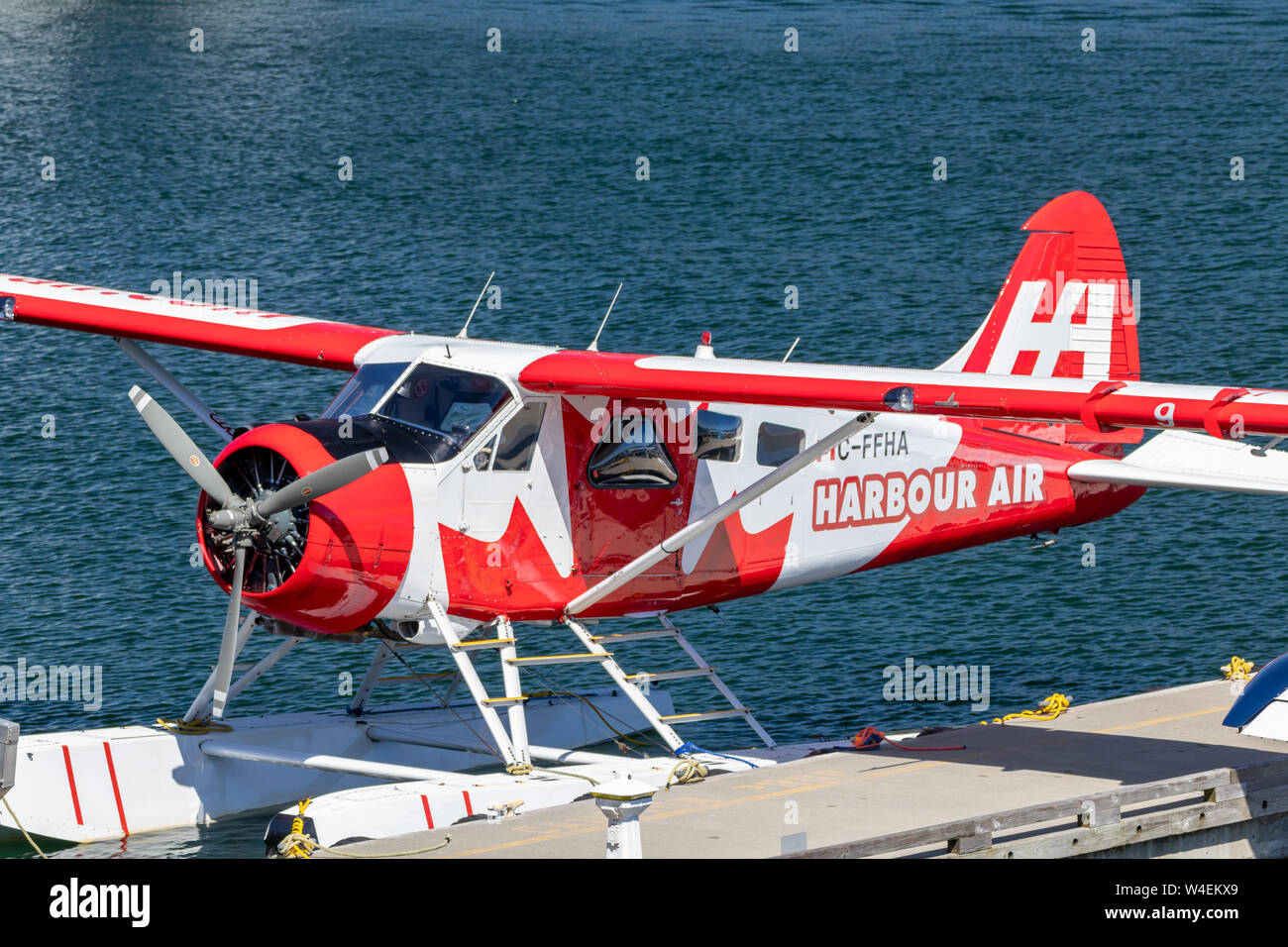 Canadian flag livery Harbour Air seaplane seen docked at Vancouver Flight Centre - Harbour Airport. Stock Photo