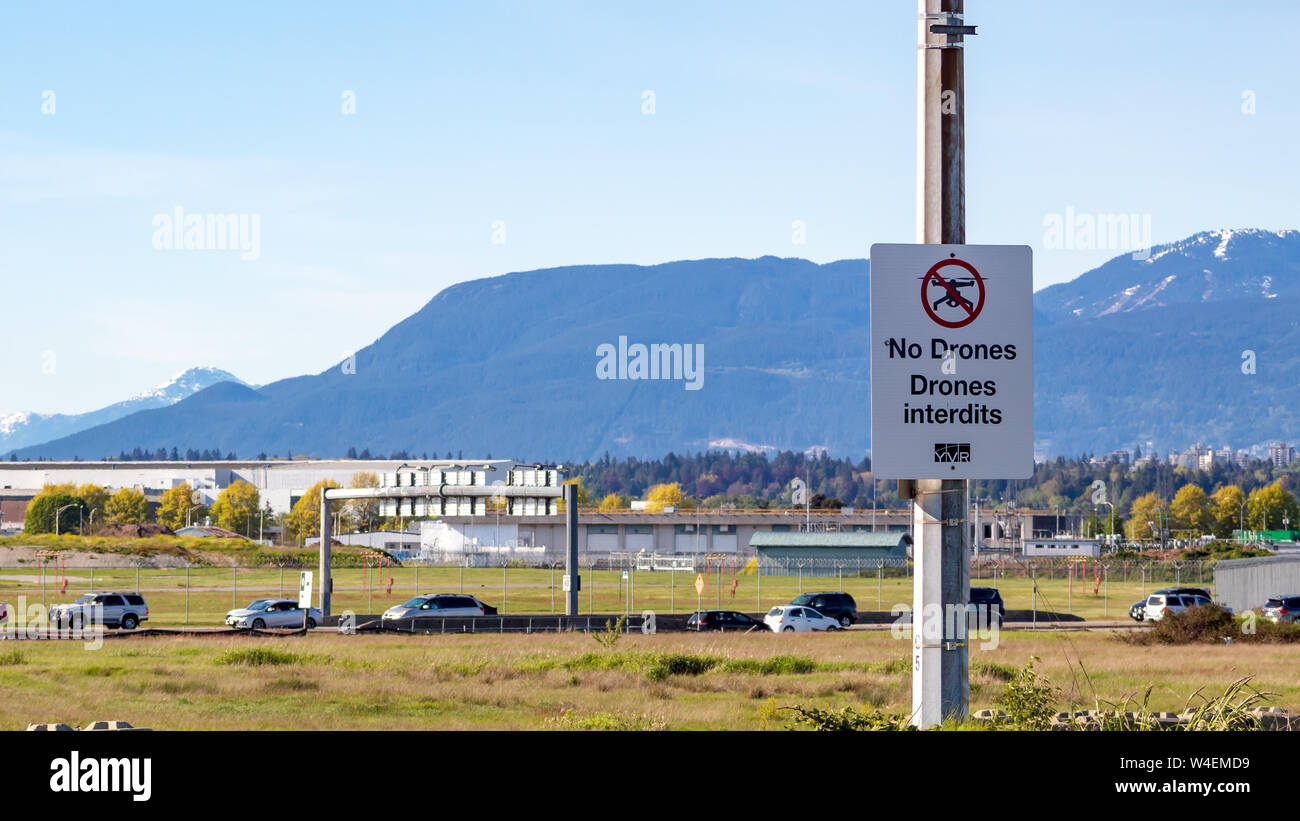 No Drones warning sign on the Dinsmore Bridge towards Vancouver International Airport with mountains in the background. Stock Photo