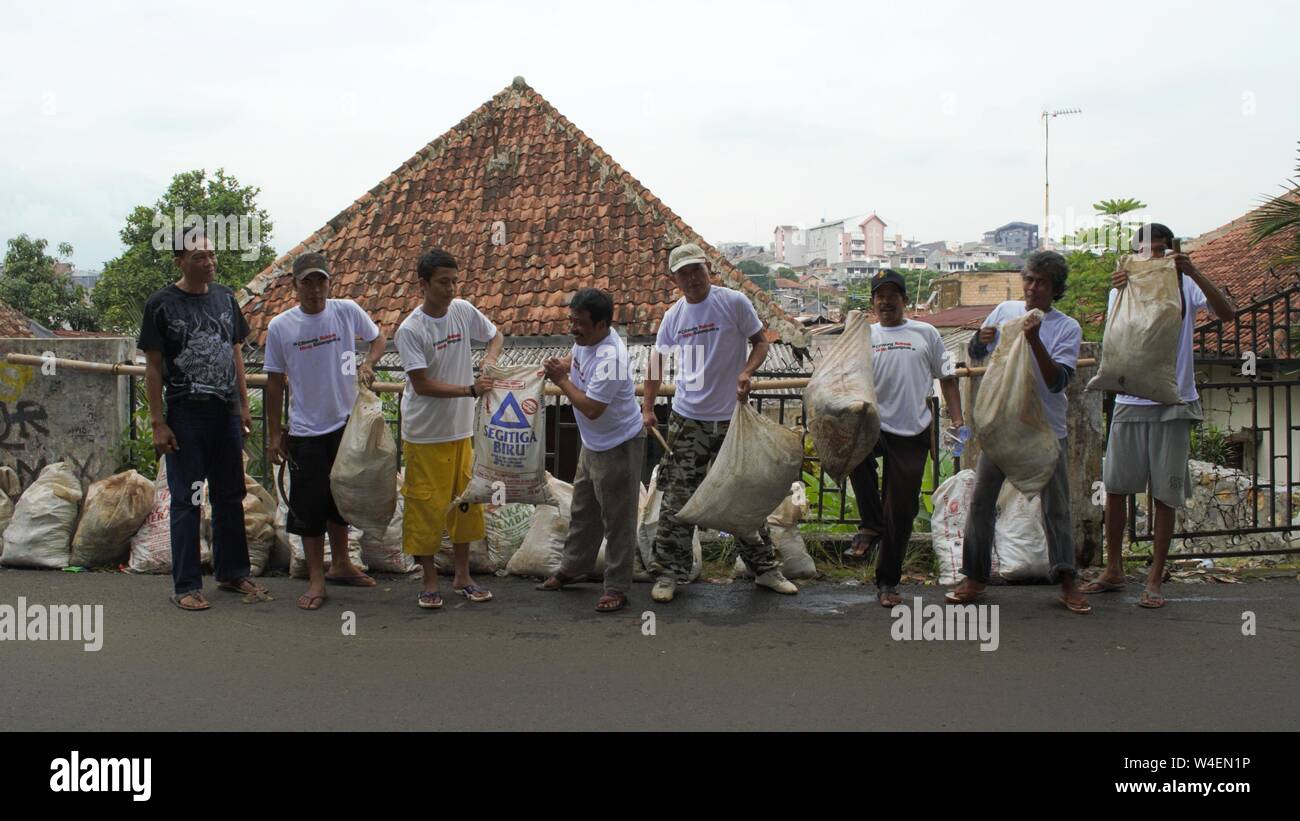 Bogor, West Java, Indonesia - July 2019 : People work together collecting trash in their neighborhood. Stock Photo