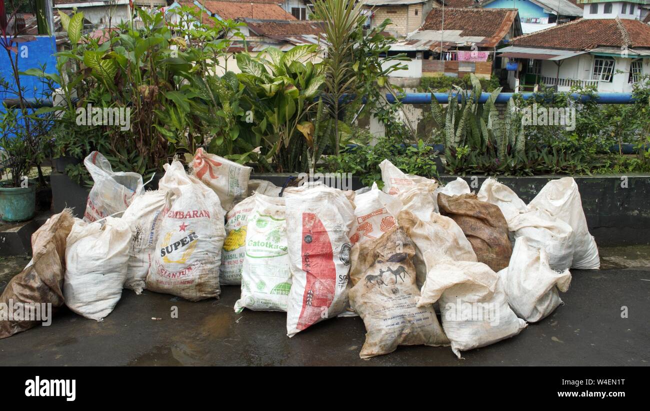 Bogor, West Java, Indonesia - July 2019 : Pack of neighborhood trash in plastic sacks. Stock Photo