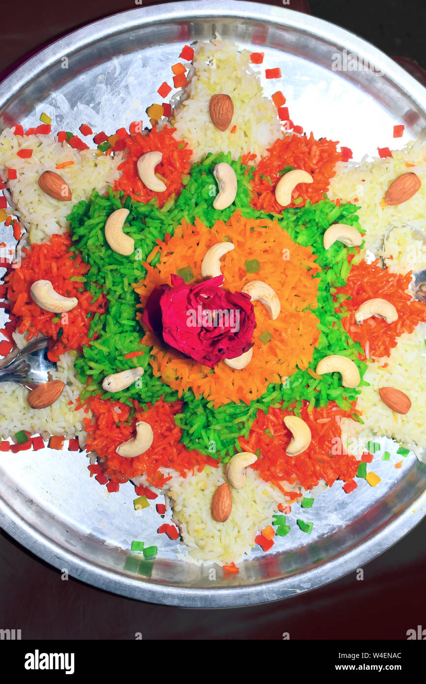boiled rice decorated with flowers and dry fruit sweet casserole, in ...