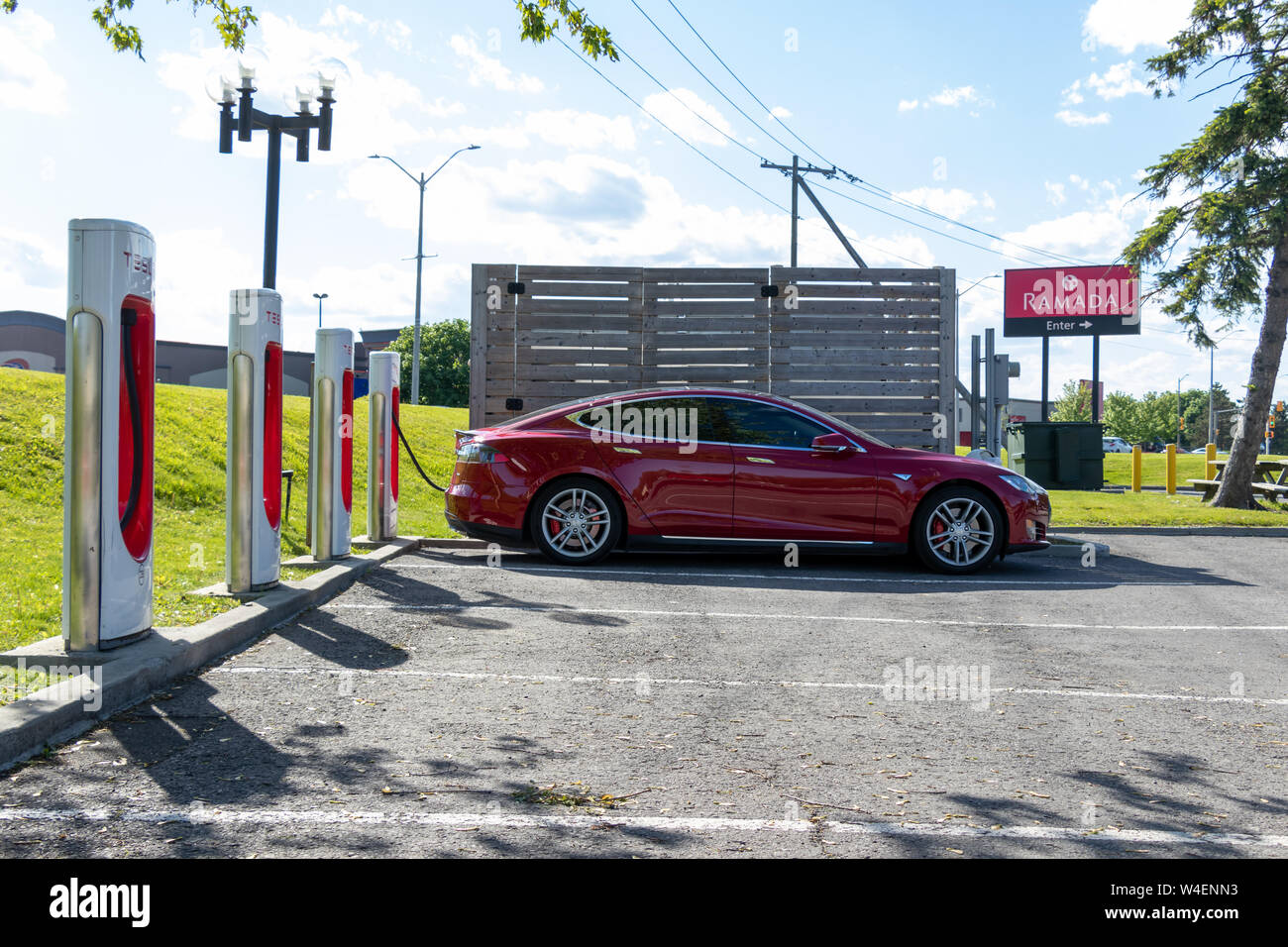 Red Tesla Model S parked, charging at Tesla Supercharger in Cornwall, Ontario Stock Photo Alamy
