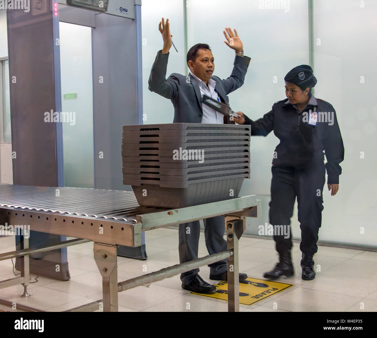 BANGKOK, THAILAND, NOV 27 2018, Control passengers and his baggage at the airport. Security officer at the airport checked people before departure. Stock Photo