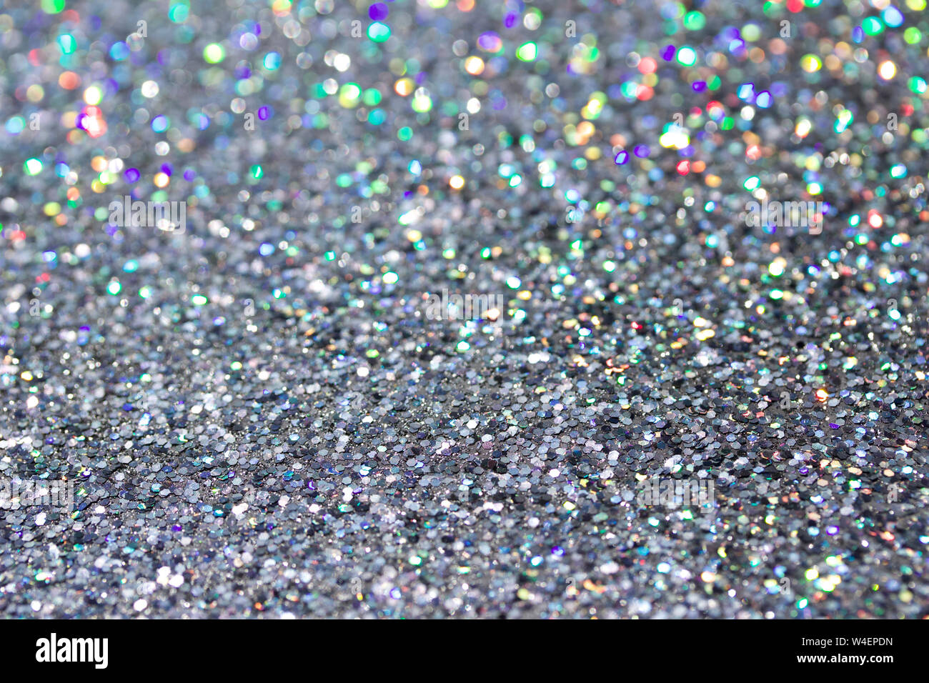 Macro abstract texture background of sparkling silver glitter reflecting  colorful bokehdsx Stock Photo - Alamy