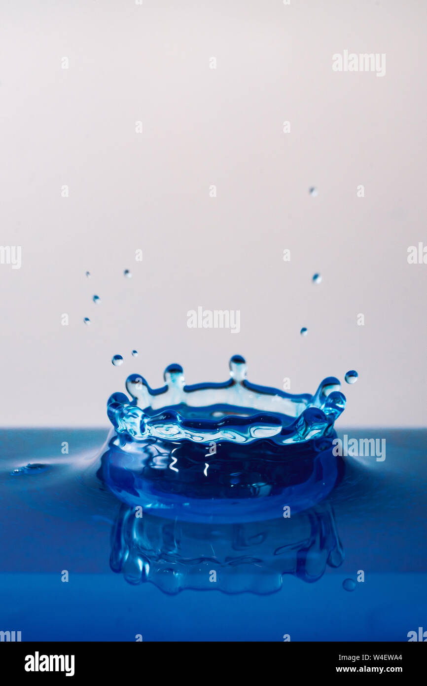Drop of water, blue water drop, water splash close-up isolated on white background, a lot of bubbles, liquid motion Stock Photo
