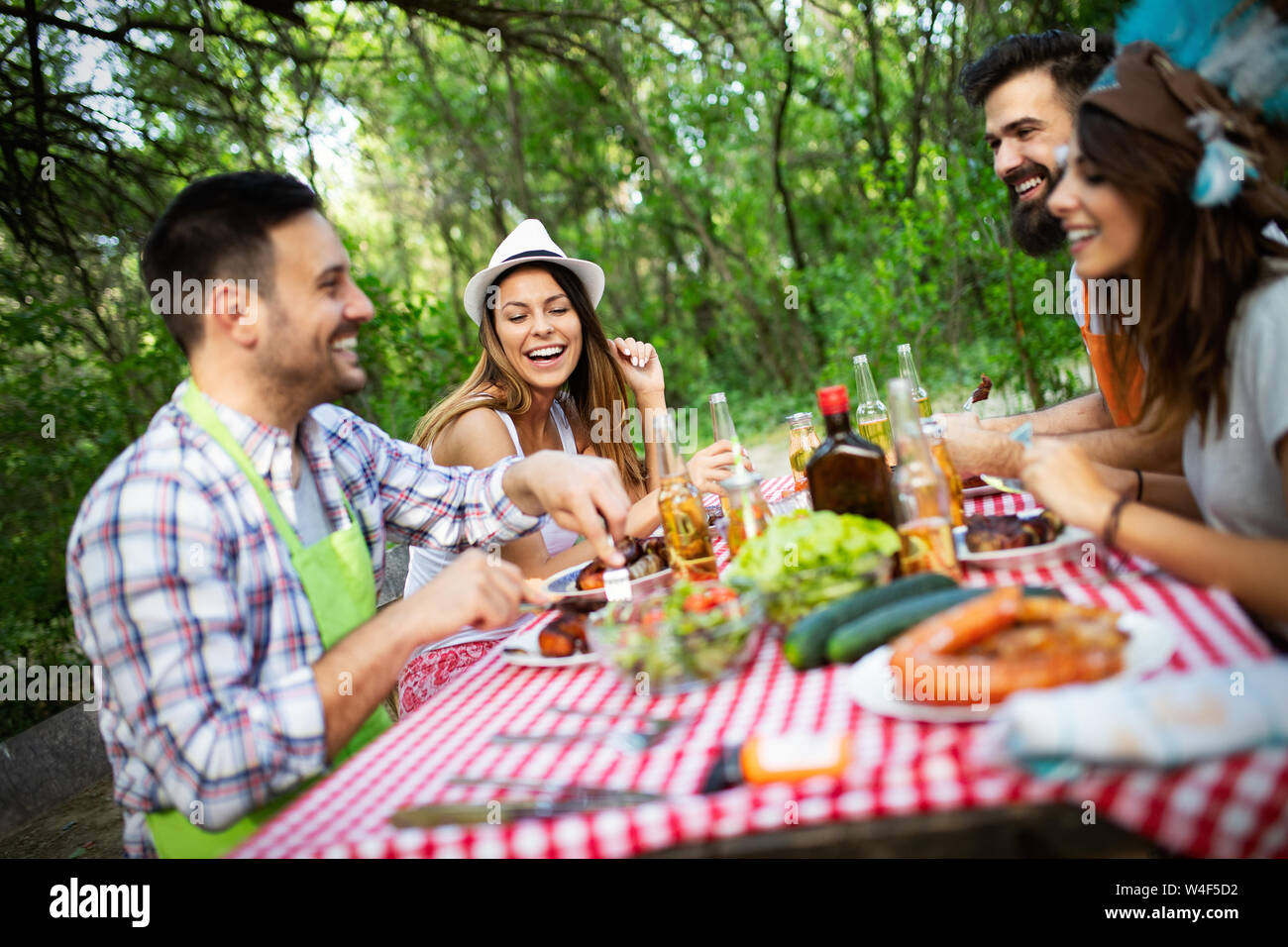 Group of friends having barbecue party in nature Stock Photo - Alamy
