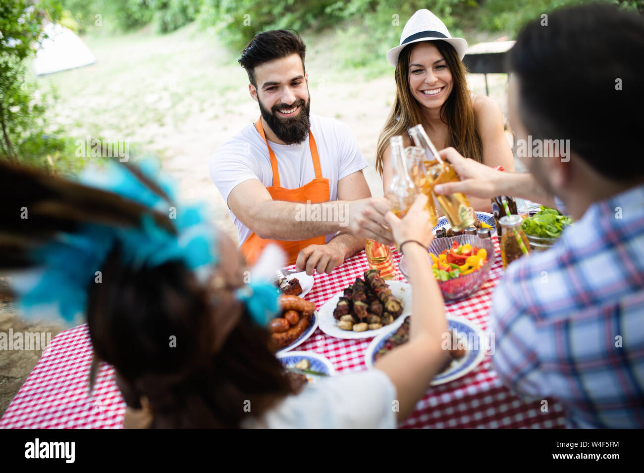Group of happy friends having a barbecue party in nature Stock Photo ...