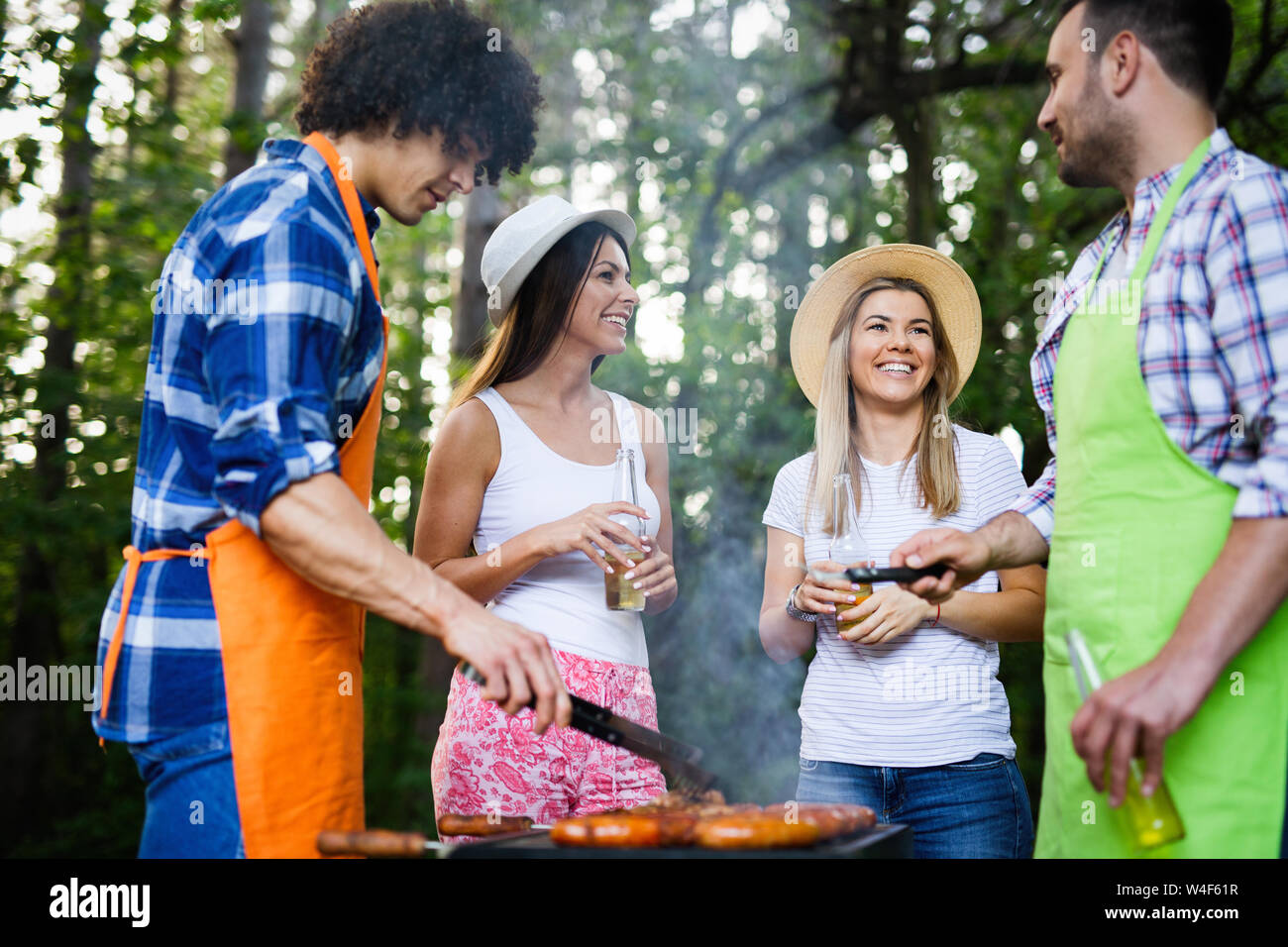Group of happy friends having a barbecue party in nature Stock Photo ...