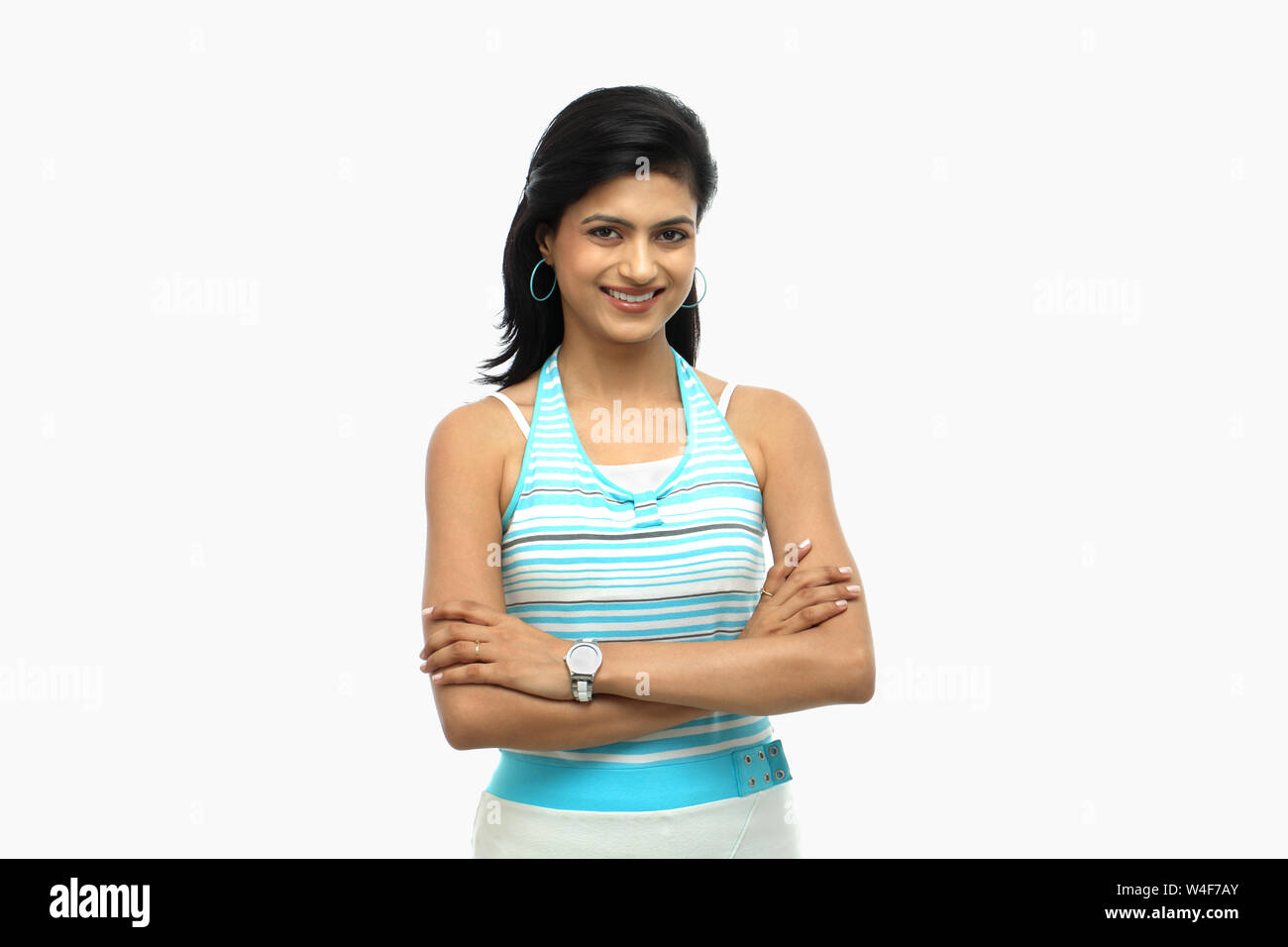 Woman smiling with her arms crossed Stock Photo - Alamy