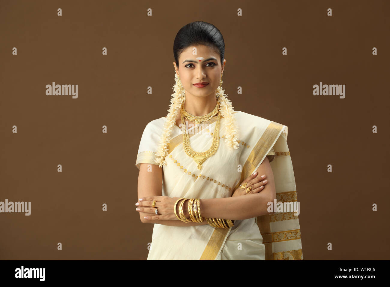 South Indian woman standing with her arms crossed Stock Photo - Alamy