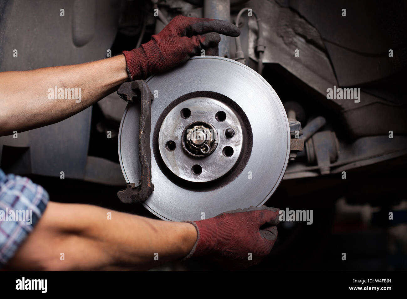 Car mechanic Repairing brakes on car Stock Photo Alamy