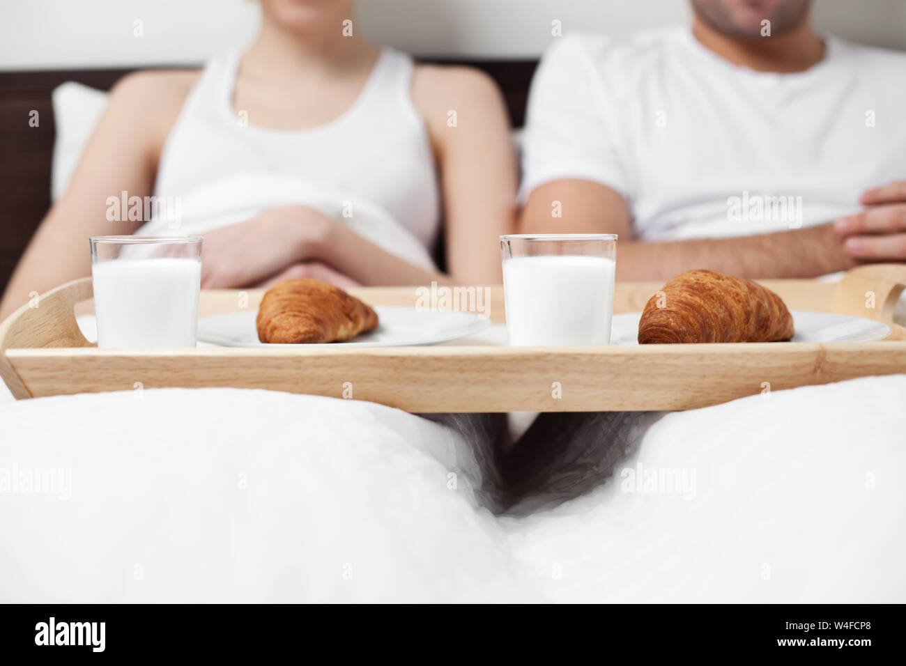 Couple eating breakfast in bed Stock Photo