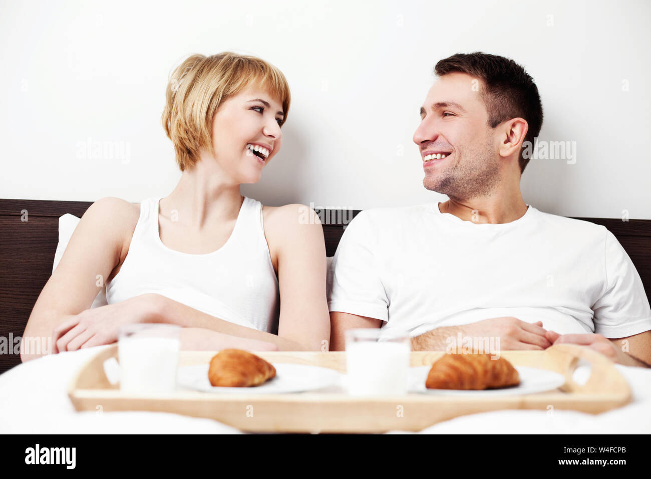 Couple eating breakfast in bed Stock Photo