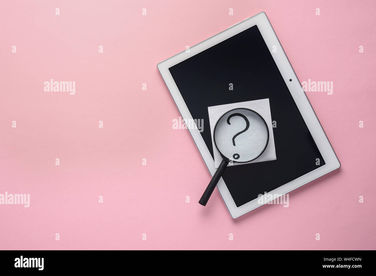 concept of searching tablet, question mark and magnifying