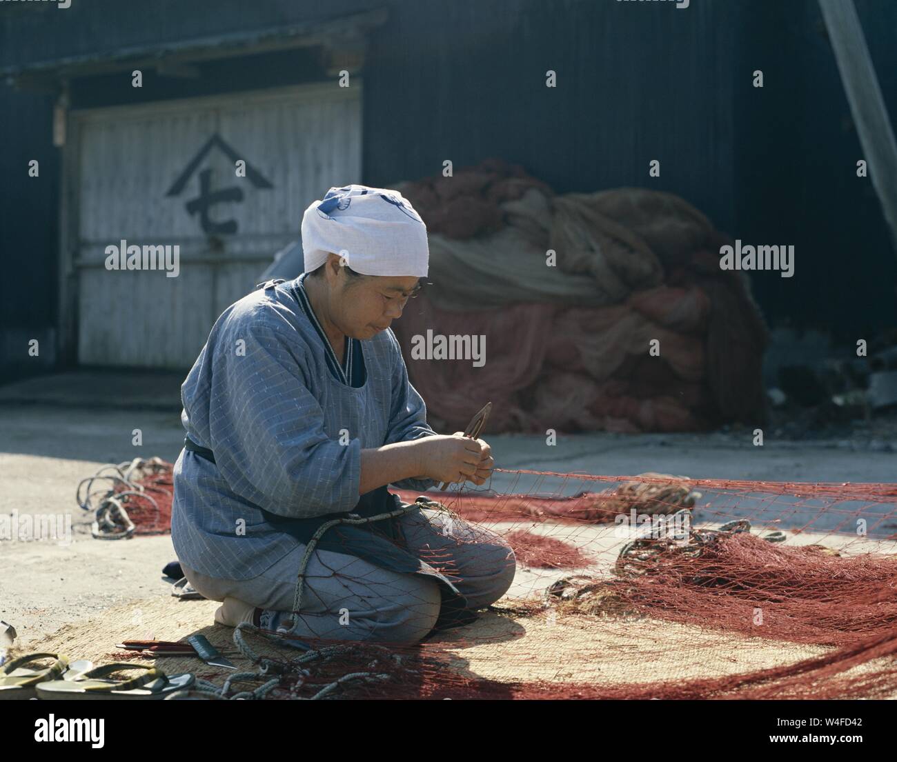 Woman Repairing Fishing Nets High Resolution Stock Photography and