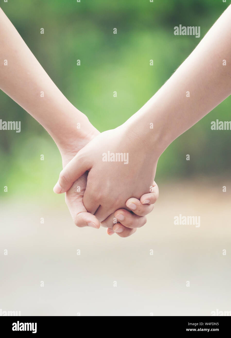 two asian woman holding hands and moving foward Stock Photo