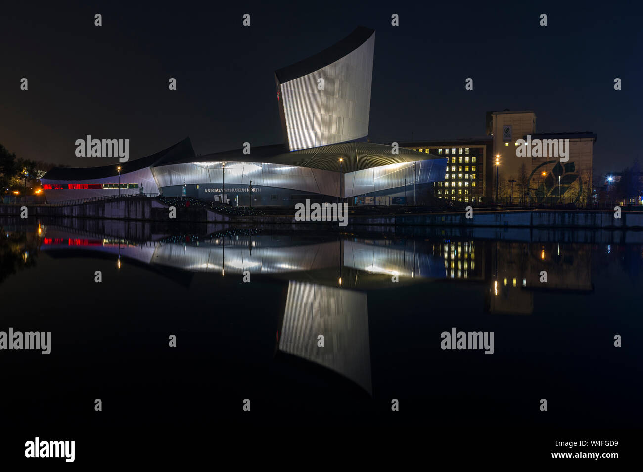 The Imperial War Museum North at night, over the Manchester Ship Canal ...