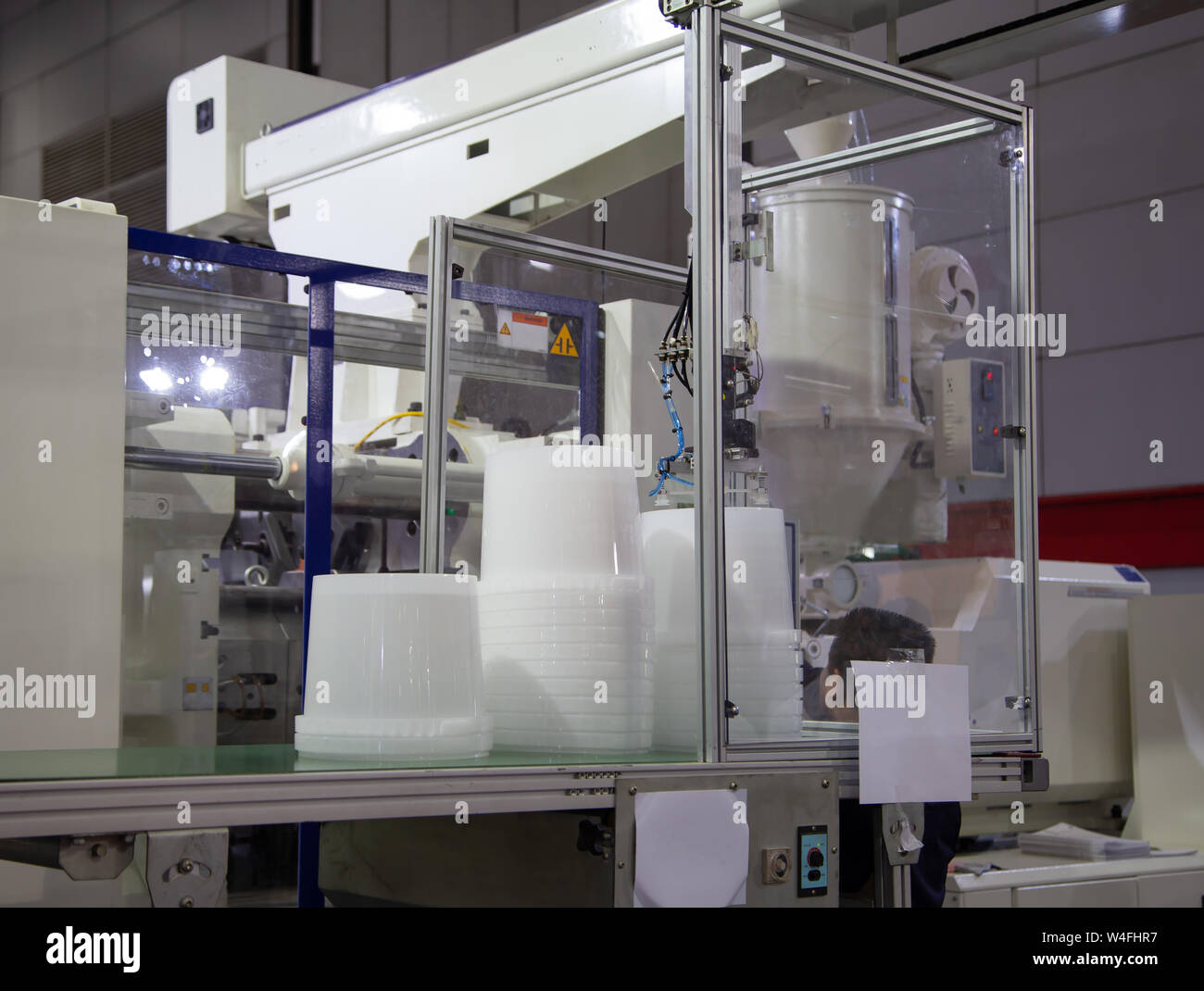 Plastic buckets product from automatic plastic injection molding press machine Stock Photo