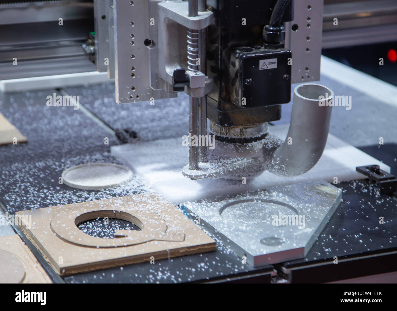 CNC Laser engraving machine carving alphabet on plastic plate Stock Photo -  Alamy